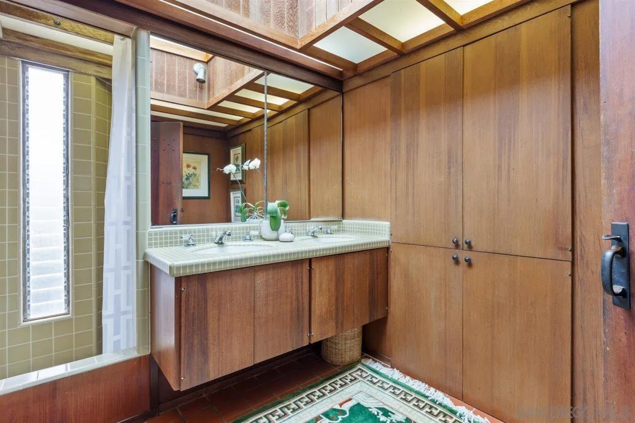 7944 Princess Street La Jolla, CA 92037 - Photo 22 of 39 a bathroom with a sink and a mirror