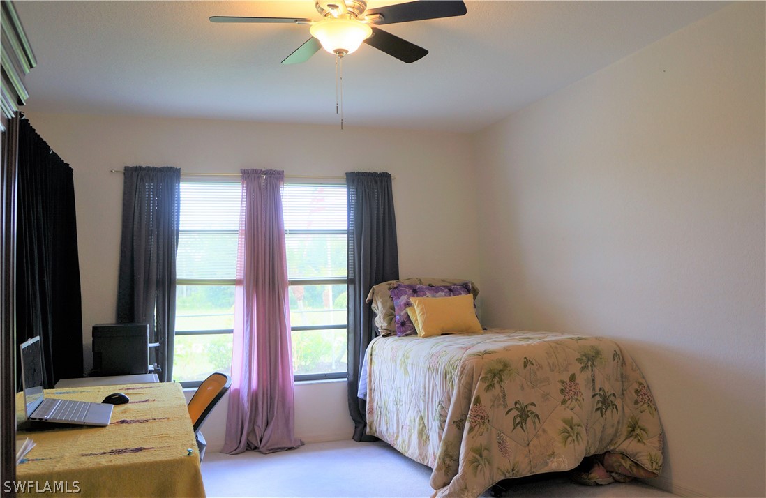 30337 Beech Road Punta Gorda, FL 33982 - Photo 27 of 33 a bedroom with a bed and wooden floor