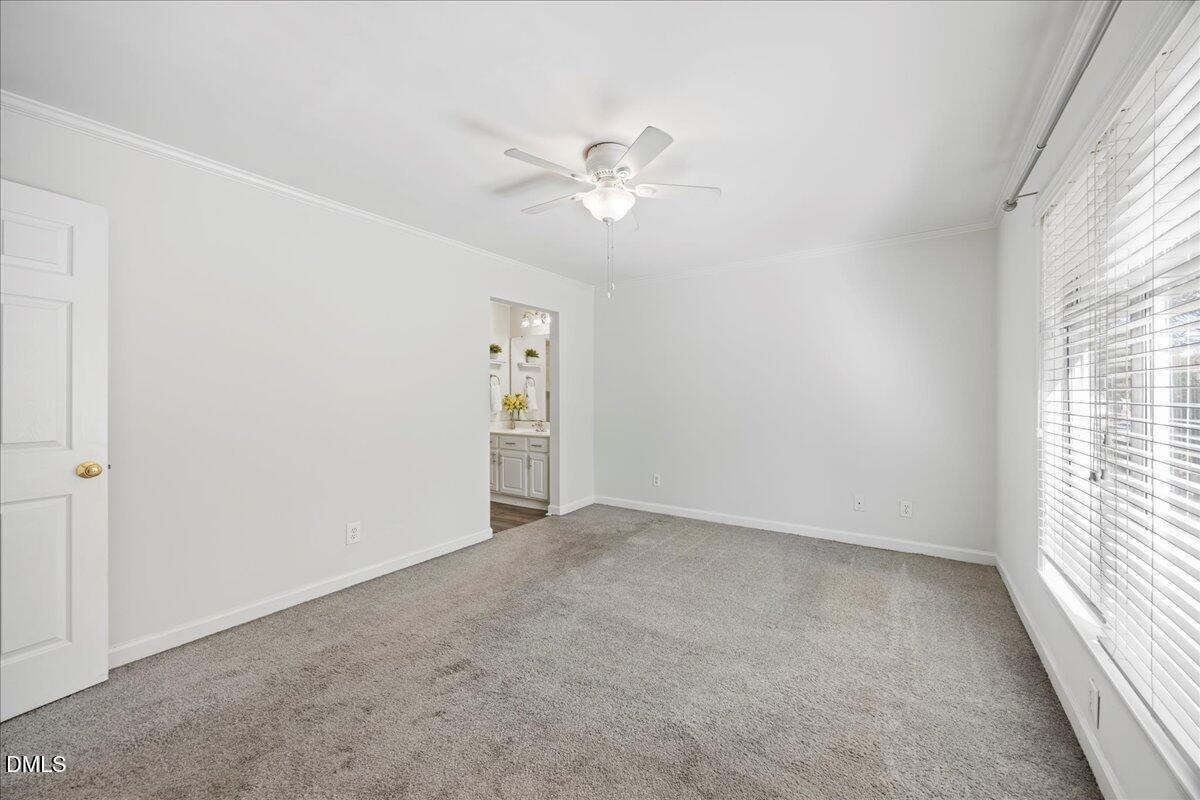 1101 Parkridge Lane, Unit 107 Raleigh, NC 27605 - Photo 19 of 33 an empty room with windows and fan