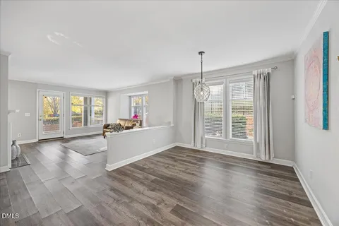 a living room with stainless steel appliances furniture and flat screen tv