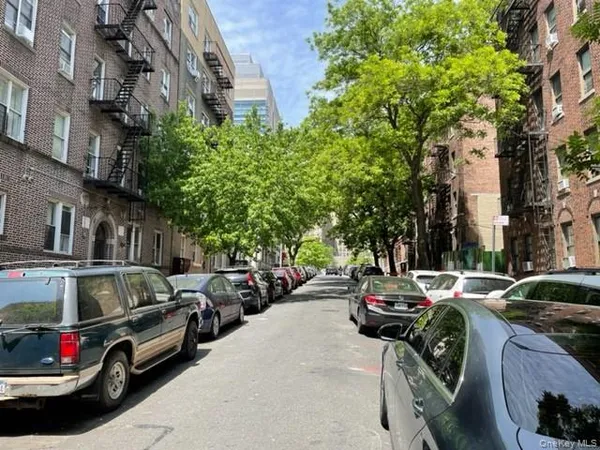 a view of street with parked cars