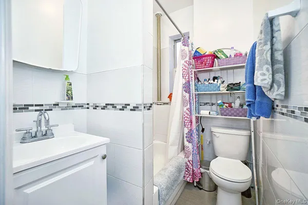 a bathroom with a sink mirror vanity and toilet