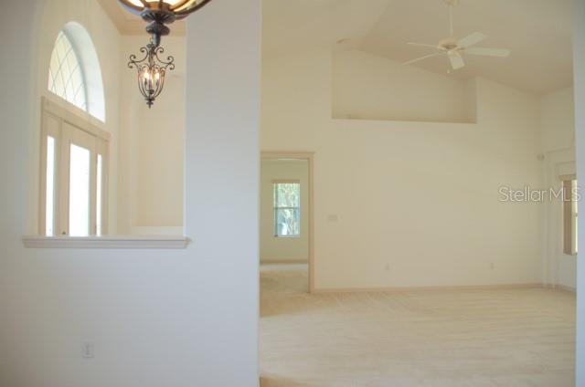 8 Eastland Lane Palm Coast, FL 32164 - Photo 11 of 60 a view of a chandelier fan and wooden floor