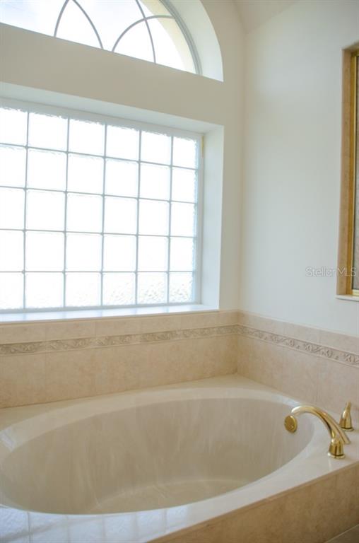 8 Eastland Lane Palm Coast, FL 32164 - Photo 15 of 60 a bathroom with a bathtub and next to a window