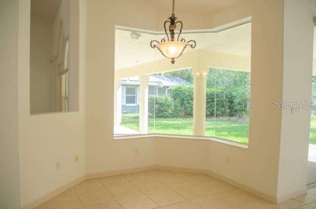 8 Eastland Lane Palm Coast, FL 32164 - Photo 19 of 60 a view of a room with a window and chandelier