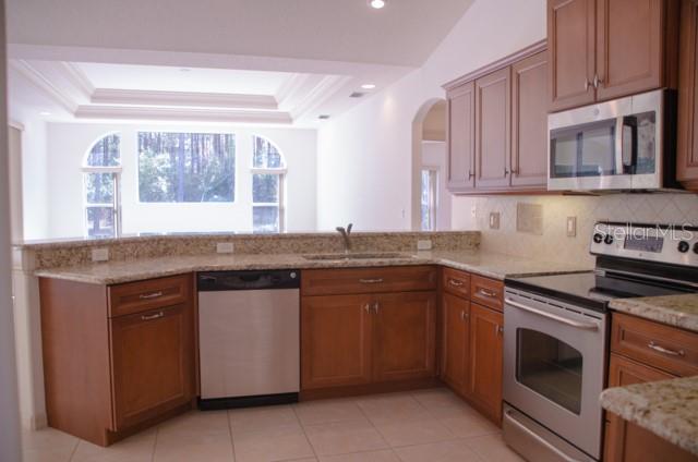 8 Eastland Lane Palm Coast, FL 32164 - Photo 21 of 60 a kitchen with granite countertop cabinets stainless steel appliances and a sink