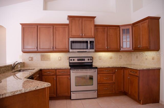 8 Eastland Lane Palm Coast, FL 32164 - Photo 22 of 60 a kitchen with sink a microwave and cabinets