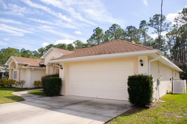 8 Eastland Lane Palm Coast, FL 32164 - Photo 3 of 60 a view of a house with a garage