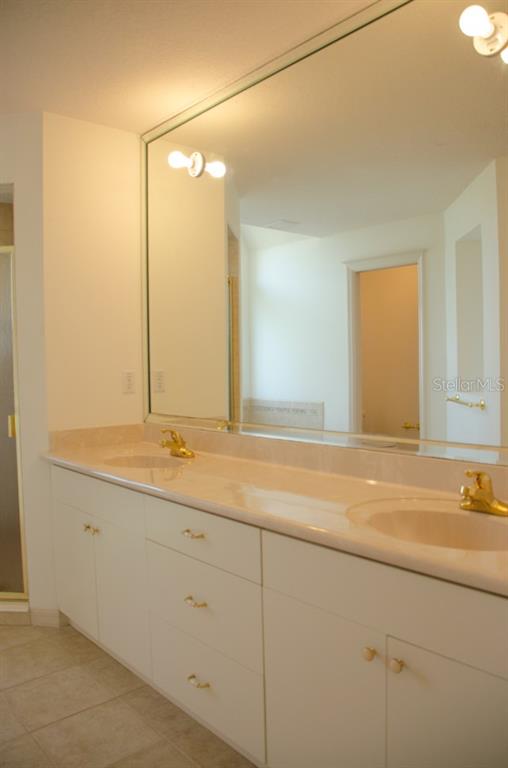 8 Eastland Lane Palm Coast, FL 32164 - Photo 43 of 60 a bathroom with a sink and a mirror