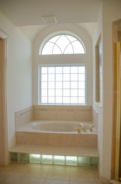 8 Eastland Lane Palm Coast, FL 32164 - Photo 46 of 60 a bathroom with a bathtub and a window