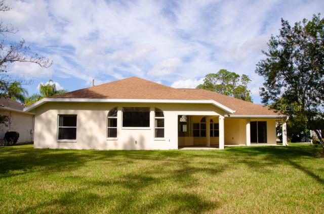 8 Eastland Lane Palm Coast, FL 32164 - Photo 54 of 60 a front view of a house with a garden