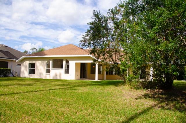 8 Eastland Lane Palm Coast, FL 32164 - Photo 56 of 60 a front view of a house with a garden