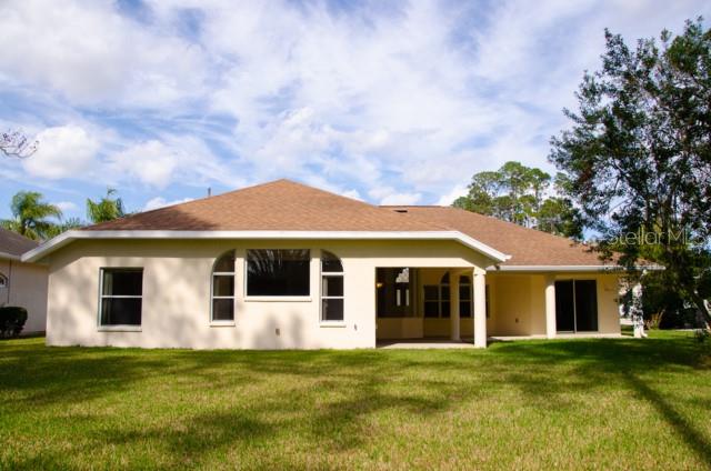 8 Eastland Lane Palm Coast, FL 32164 - Photo 57 of 60 a front view of a house with a garden
