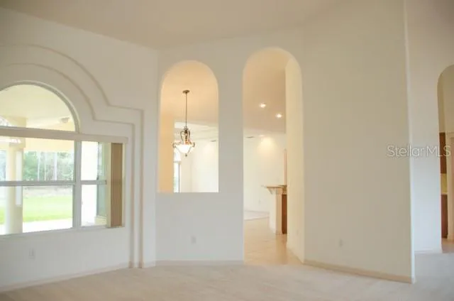 a view of a chandelier fan and wooden floor