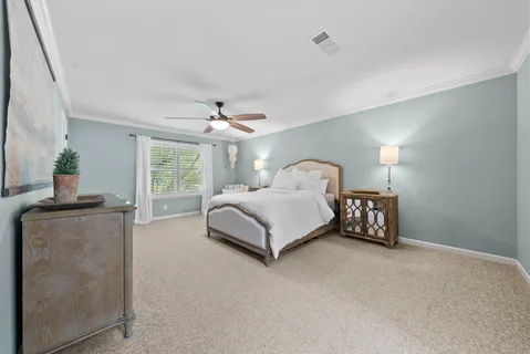 a bedroom with a bed lamp and window