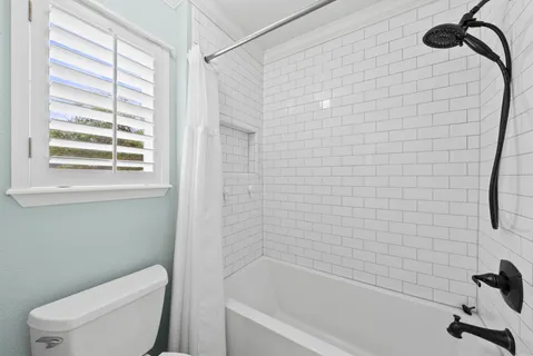 a bathroom with a toilet and a bathtub