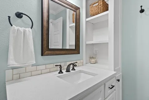 a bathroom with a sink and a mirror