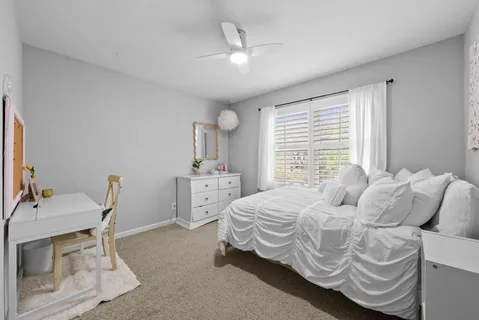 a bedroom with a bed a desk and chair