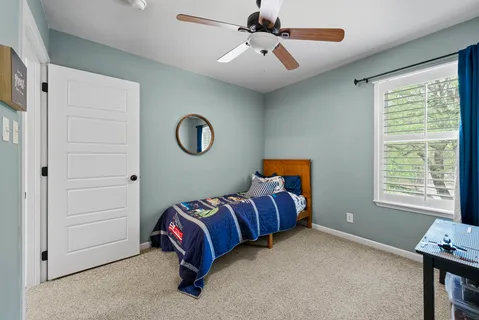 a bedroom with bed and a window