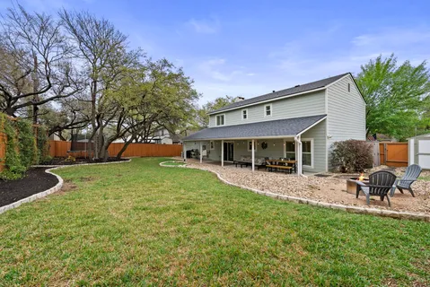 a view of a house with a yard porch and sitting area