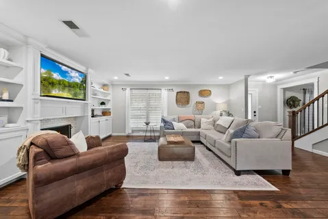 a living room with fireplace furniture and a flat screen tv