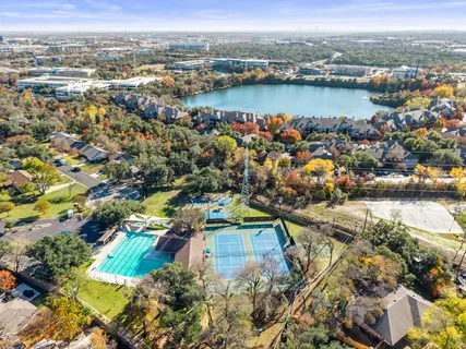 an aerial view of ocean and residential houses with outdoor space
