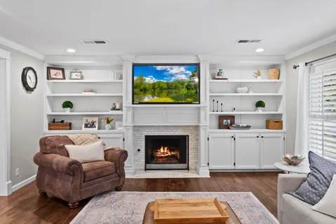a living room with furniture and a fireplace