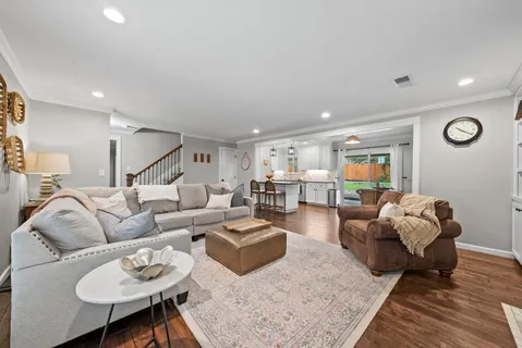 a living room with furniture kitchen view and a table
