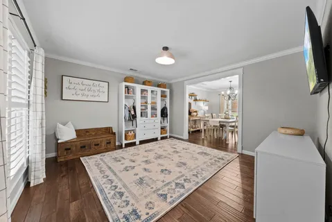a living room with furniture and flat screen tv