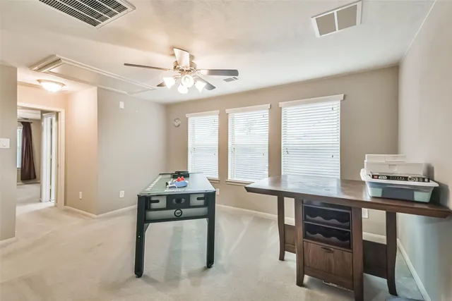 a spacious bedroom with a bed and a window