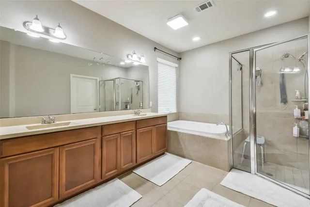 a bathroom with a bathtub and a shower