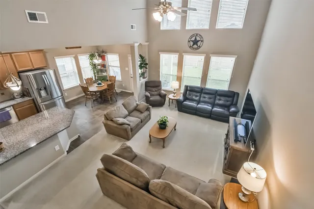 a kitchen with stainless steel appliances granite countertop a sink a stove and refrigerator