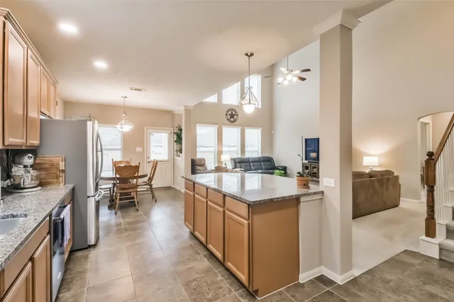 a kitchen with stainless steel appliances granite countertop a sink a stove and a microwave