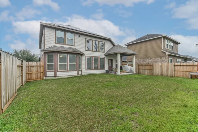a view of a house with a yard and sitting area