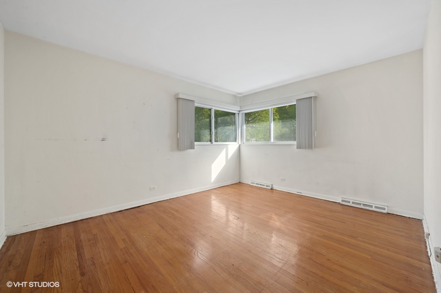 405 Locust Road Wilmette, IL 60091 - Photo 14 of 16 an empty room with wooden floor and windows