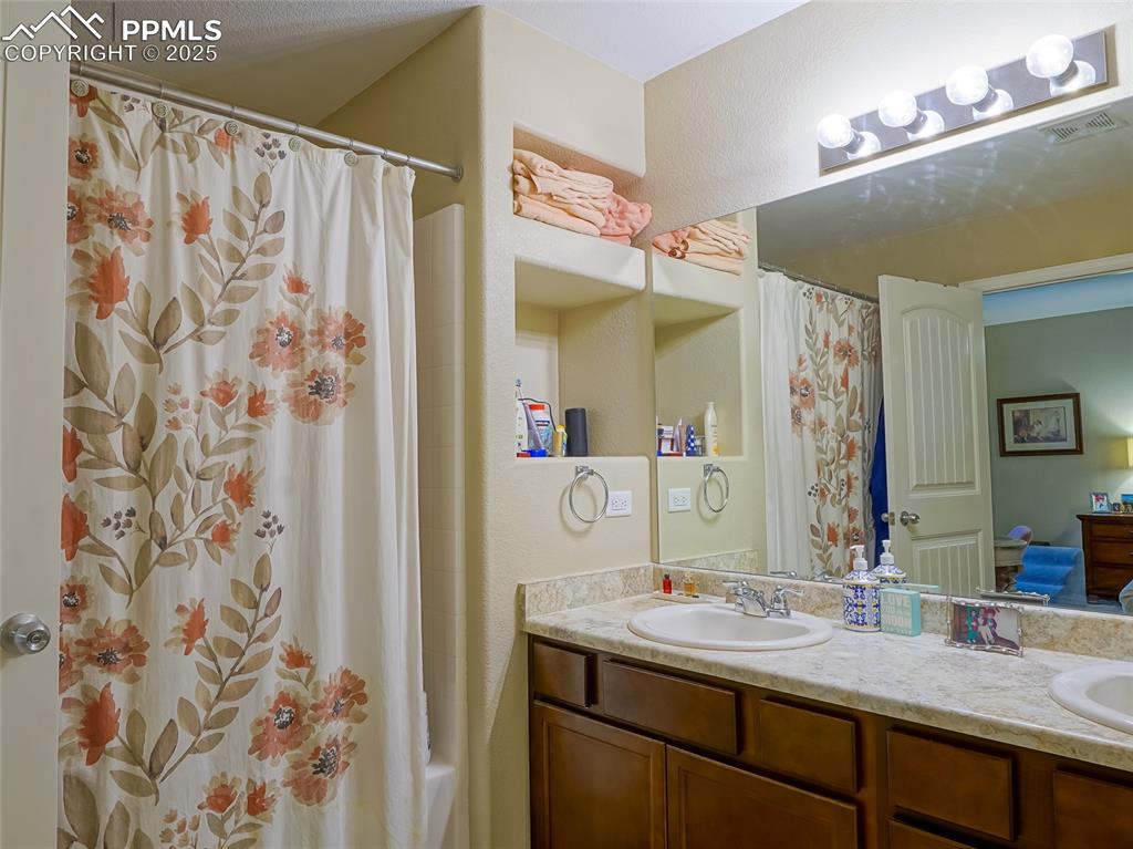 4792 Kerry Lynn View Colorado Springs, CO 80922 - Photo 15 of 34 a bathroom with a granite countertop sink and a mirror