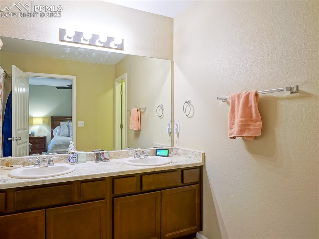 4792 Kerry Lynn View Colorado Springs, CO 80922 - Photo 16 of 34 a bathroom with a sink and a mirror