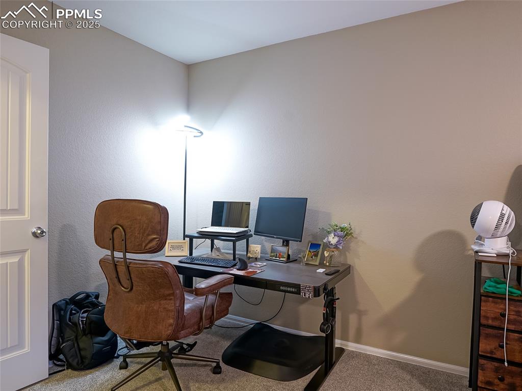 4792 Kerry Lynn View Colorado Springs, CO 80922 - Photo 18 of 34 a view of a workspace with furniture and a window