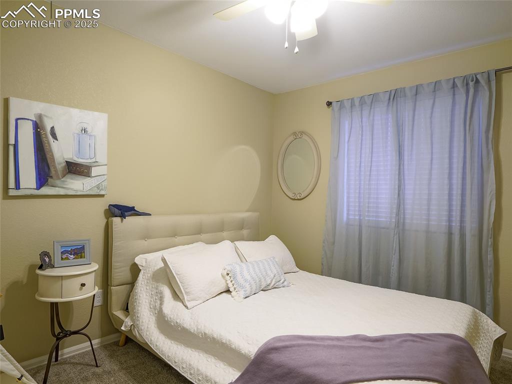 4792 Kerry Lynn View Colorado Springs, CO 80922 - Photo 20 of 31 a bedroom with a bed and a table in it