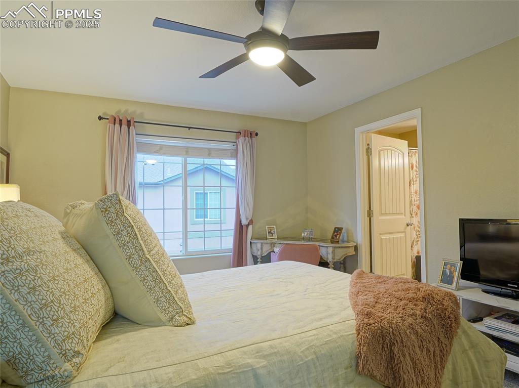 4792 Kerry Lynn View Colorado Springs, CO 80922 - Photo 21 of 34 a bedroom with a bed and a tv