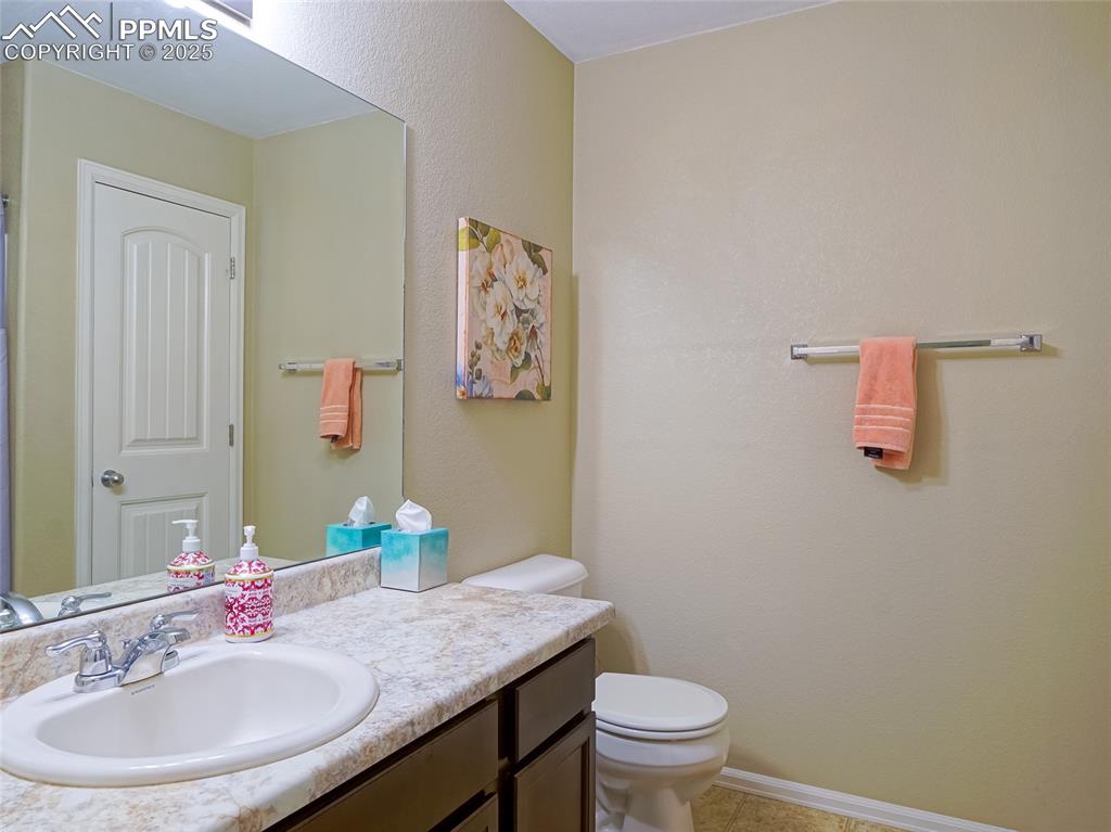 4792 Kerry Lynn View Colorado Springs, CO 80922 - Photo 23 of 34 a bathroom with a sink and a mirror with toilet