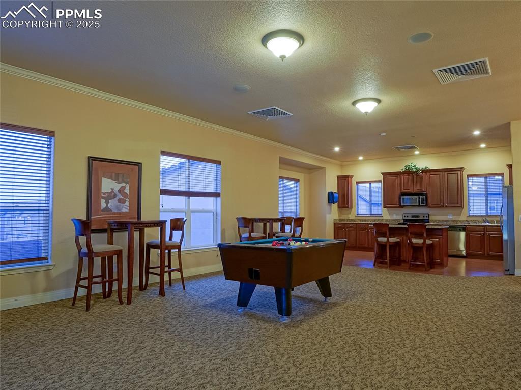4792 Kerry Lynn View Colorado Springs, CO 80922 - Photo 27 of 31 a living room with furniture a dining table and kitchen view