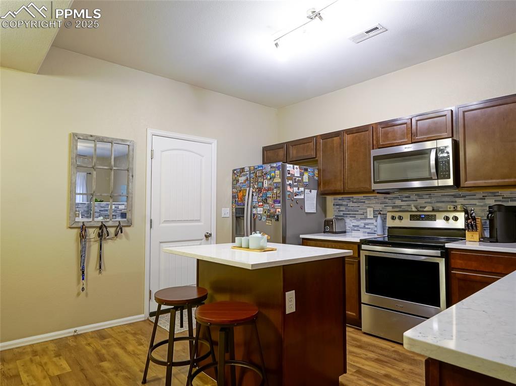 4792 Kerry Lynn View Colorado Springs, CO 80922 - Photo 7 of 31 a kitchen with a sink cabinets and appliances