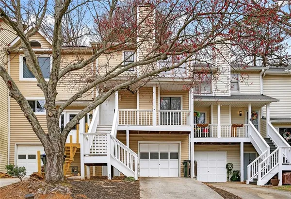 a front view of a house with large windows