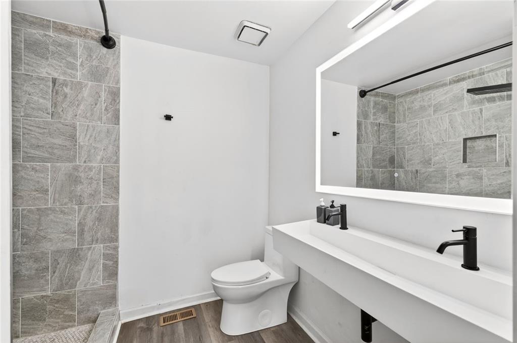 2226 Spring Walk Court Atlanta, GA 30341 - Photo 14 of 28 a bathroom with a sink a toilet and shower