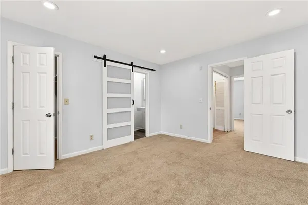 a view of an empty room with a closet