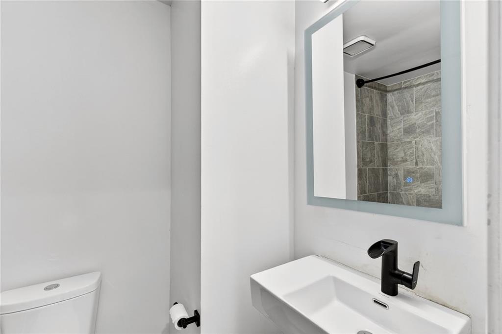 2226 Spring Walk Court Atlanta, GA 30341 - Photo 19 of 28 a bathroom with a sink and mirror