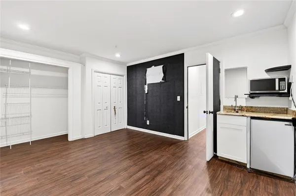 a view of a kitchen with wooden floor and a sink