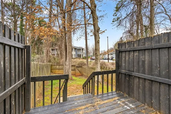 a view of balcony with wooden floor and fence