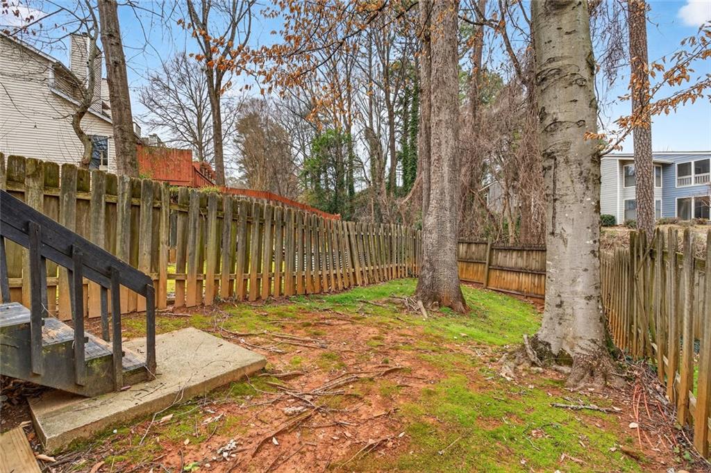 2226 Spring Walk Court Atlanta, GA 30341 - Photo 25 of 28 a view of backyard with wooden fence and a large tree